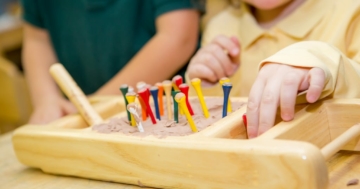 The child plays with the Montessori sensory materials