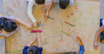 children draw together at school