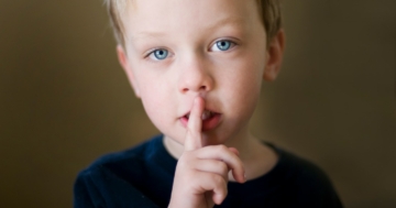 Child making a sign for silence