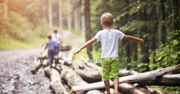 Child balancing on a log