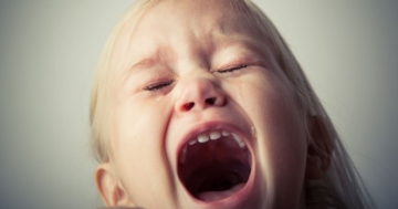 Child reacting by screaming to a ban