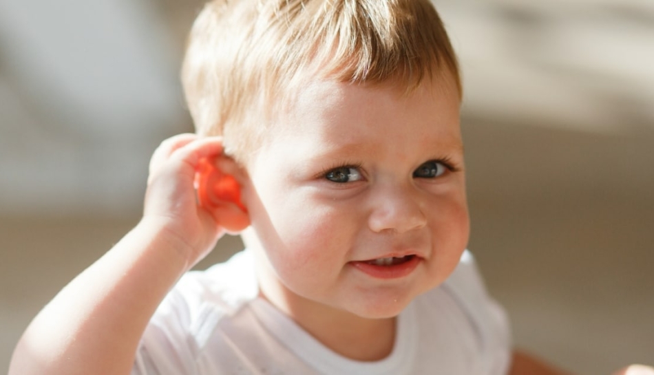 Bambino che presta attenzione mettendo una mano sull'orecchio