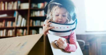 Bambina che gioca a far finta di essere un'astronauta