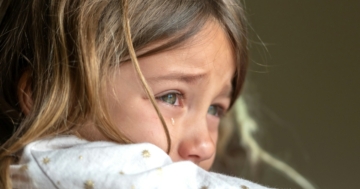 The little girl cries after the slap