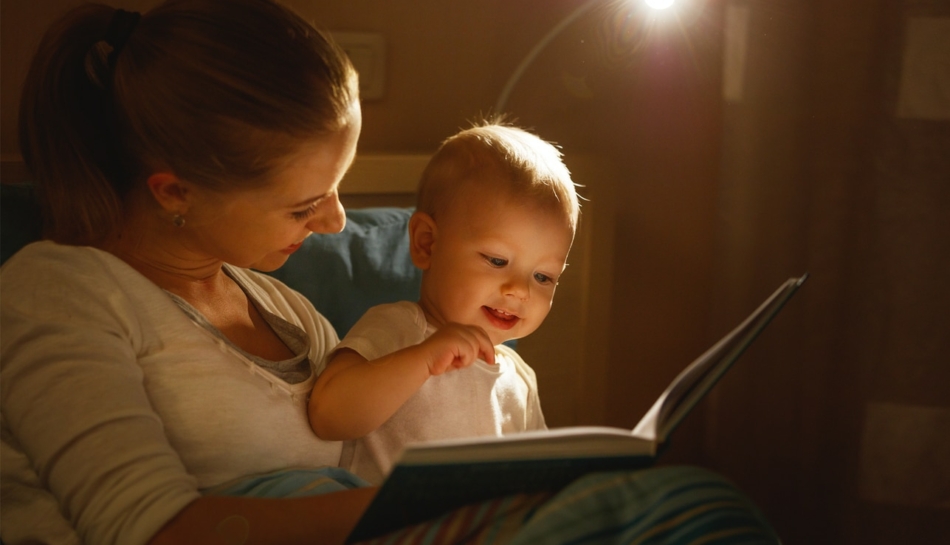 Mamma con bambino che legge un libro per imparare a parlare