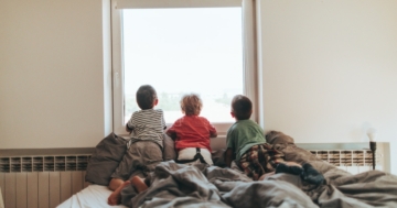 Children look out the window during quarantine