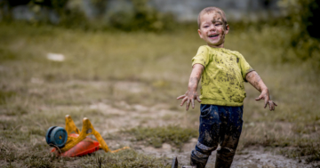 child plays with mud