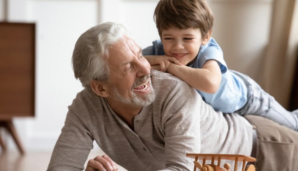 Nonno che gioca con un nipotino sulla schiena