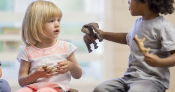 Children play together with animal puppets