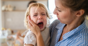 Mom comforts her child during a tantrum