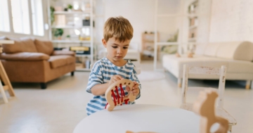 child playing in montessori house