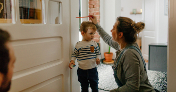 Genitori misurano l'altezza del figlio