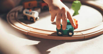 Bambino gioca con la pista di macchinine